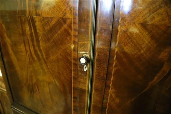 An Edwardian mahogany and boxwood line inlaid two door compactum wardrobe, W.194cm, D.61cm, H.215cm